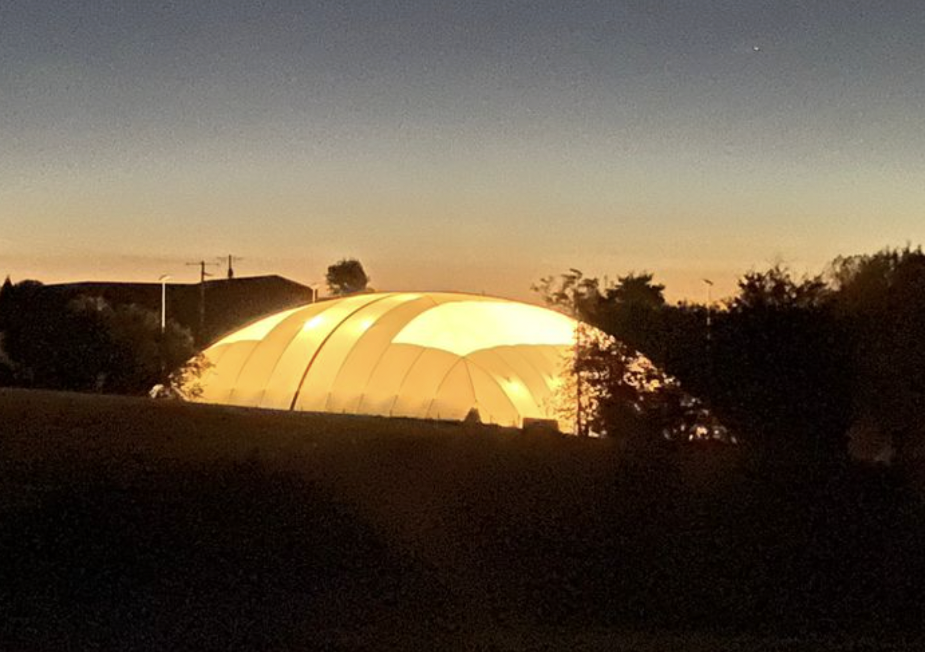 Air dome lit at night